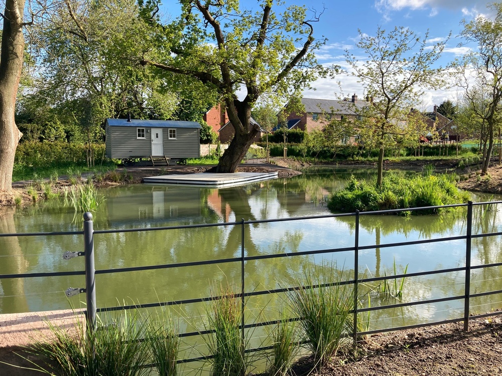 Jetty with seating area in front of shepherds hut